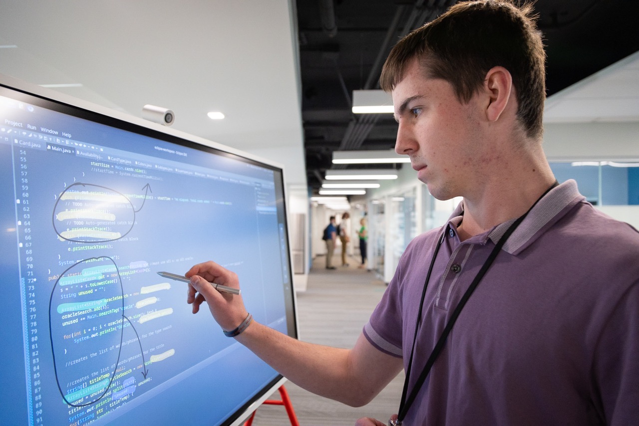 Greyson Stanton writes on a whiteboard