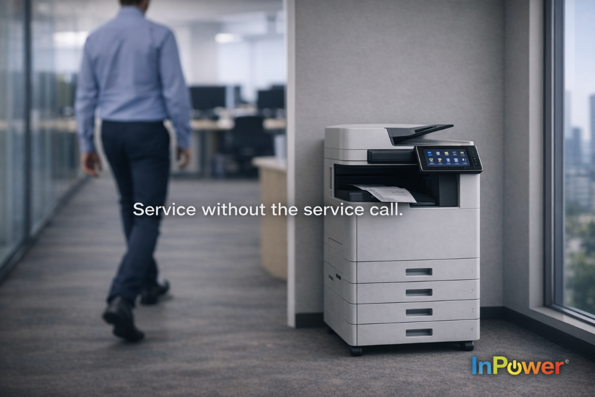 A modern office printer stands in a hallway printing a document, while a person walks away in the background. Text on the image reads, “Service without the service call,” with the InPower logo displayed in the corner.