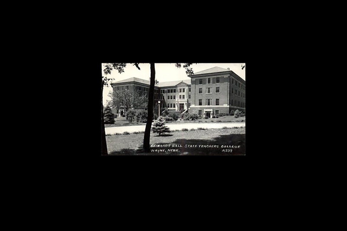 Historic black-and-white photograph of Neihardt Hall at State Teachers College in Wayne, Nebraska, viewed from across a lawn with trees.