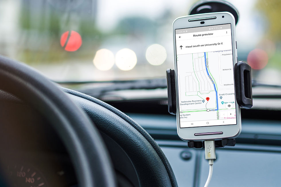Car dash with smartphone showing navigation 