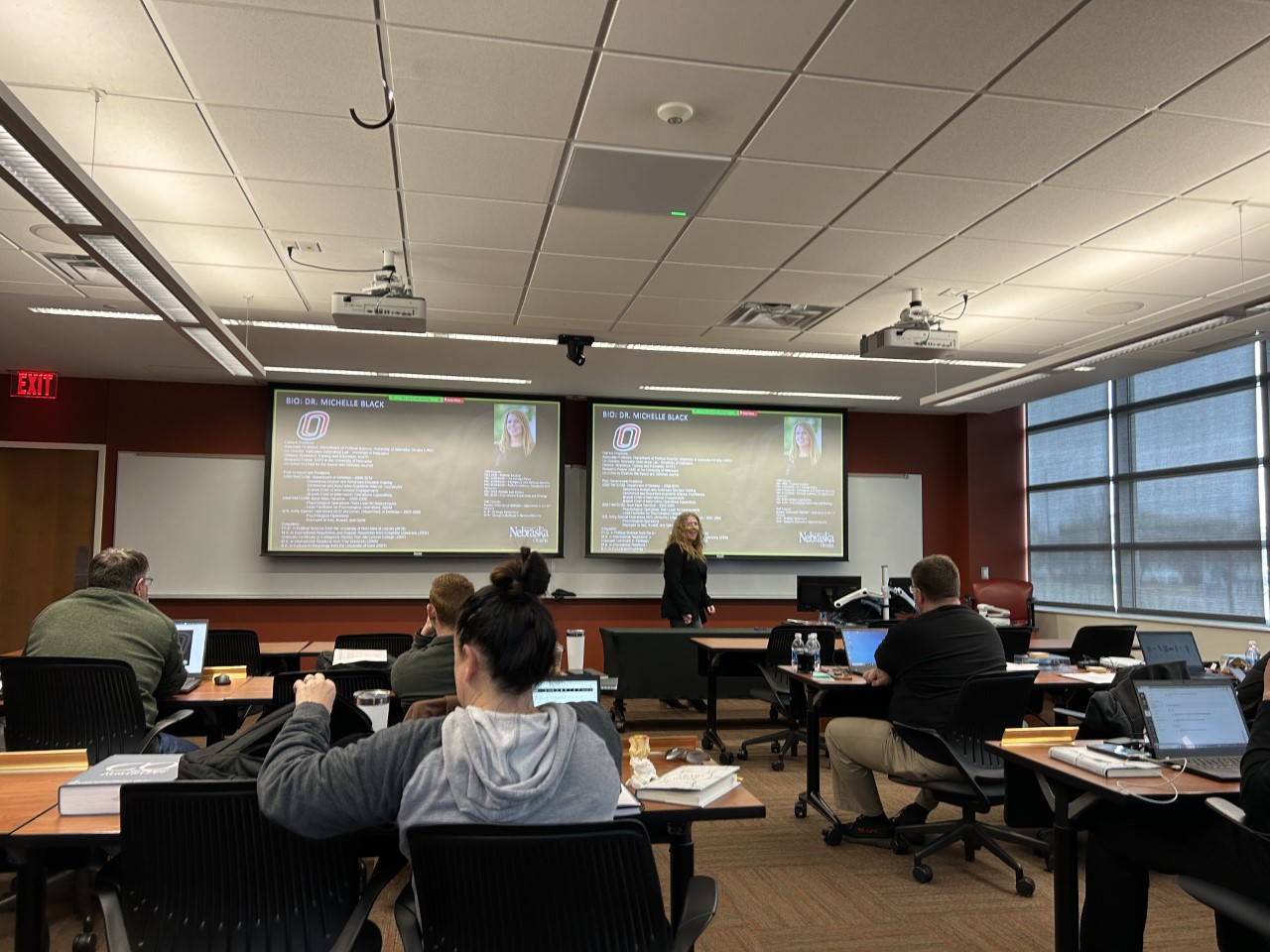 Depicts Dr Black teaching Deterrence Academics to the Strat Fellows 2023