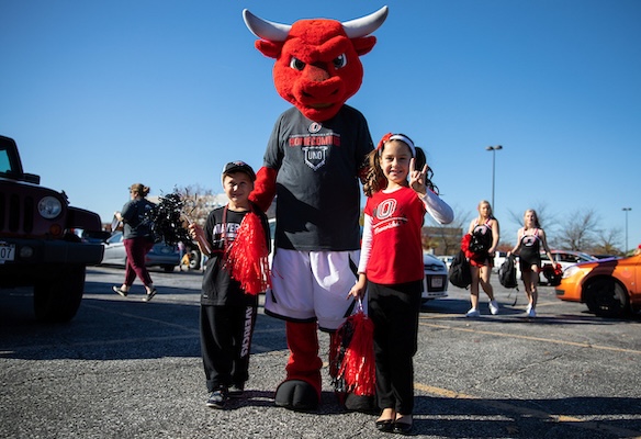 Kids hang out with UNO's mascot Durango at a tailgate event for Family Weekend.
