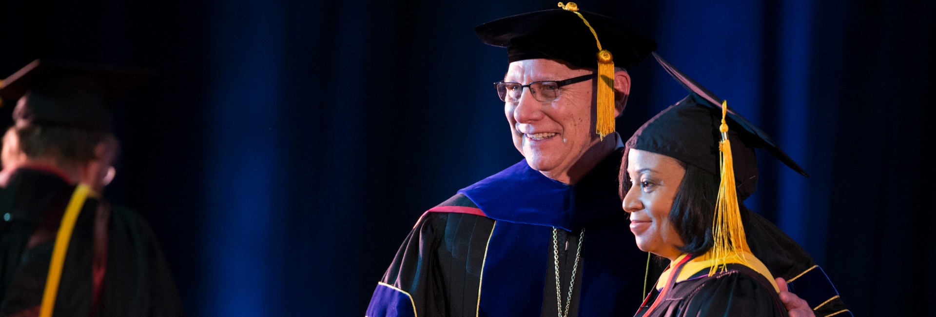 UNO Chancellor John E. Christensen with a new graduate