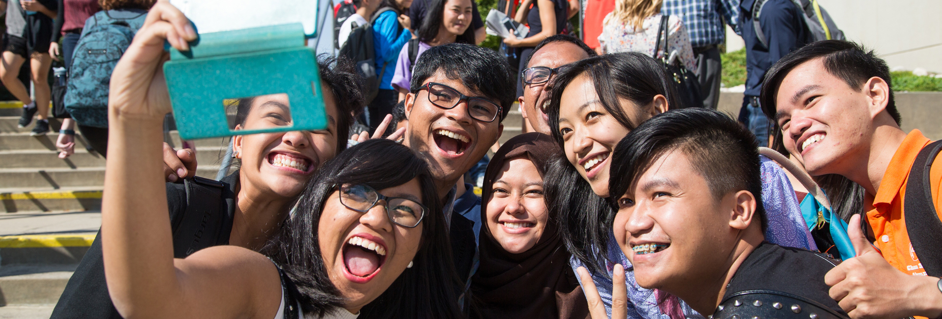 Eight of the YSEALI students pose for a selfie outside the Milo Bail Student Center.