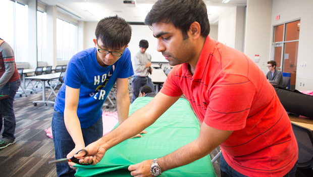 Student volunteers work on making blankets for the Veterans Day of Service, one of UNO's Signature Service Days