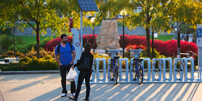 Students talk next to the Dodge Campus B-Cycle station