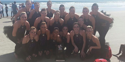 The dance team poses with their trophy at Daytona Beach, FL