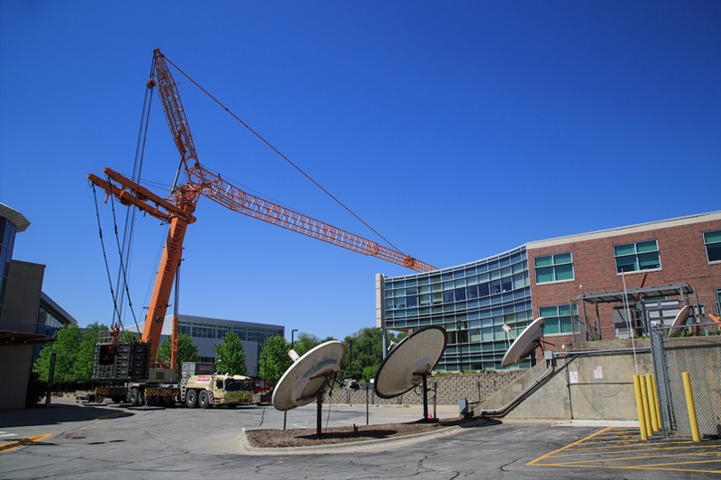 A crane helps complete the removal of a radio tower on UNO's Dodge Campus
