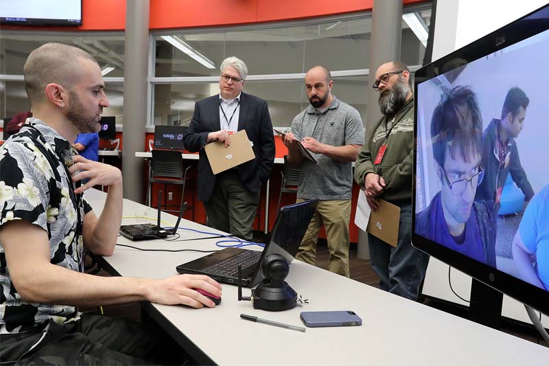 Participants in the MD5 Hackathon at UNO's Peter Kiewit Institute present their work to a panel of judges