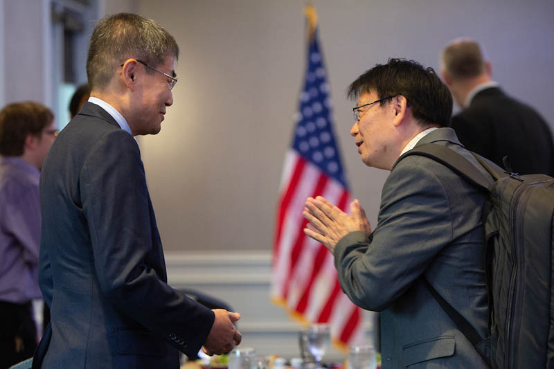 President Ishii speaks with UNO faculty member Halla Kim