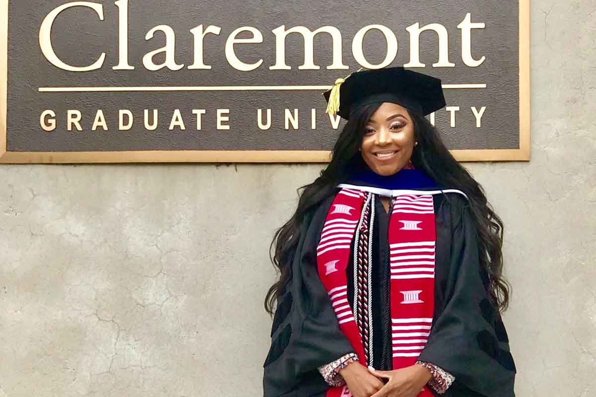Marquisha Spencer poses after earning her Ph.D. from Claremont Graduate University