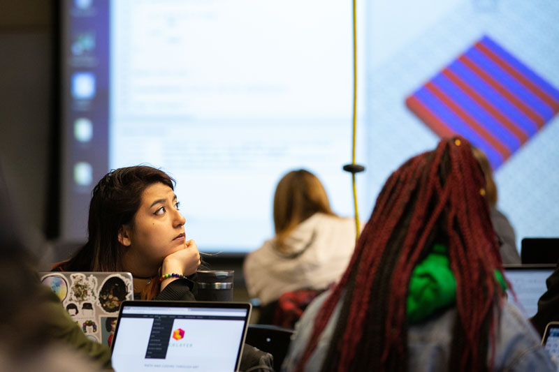 Students examine a math and coding problem provided by Bricklayer