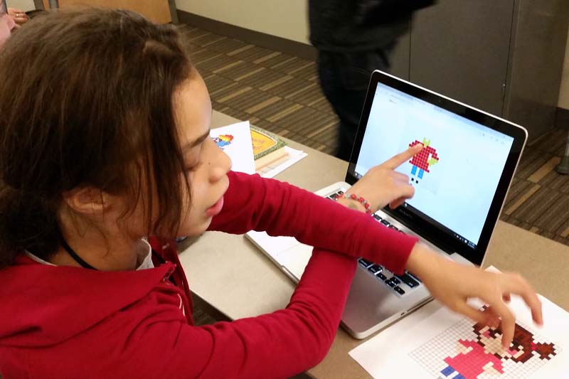 A participant of the Eureka! STEM program learns Bricklayer