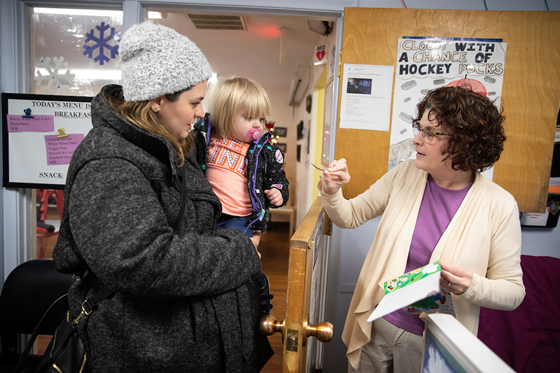 A student picks up their child from the UNO Child Care Center in 2018.