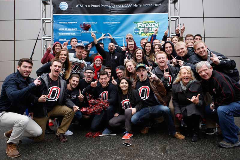 Students stand in front of a "Frozen Four" sign before UNO's appearance in the NCAA Championship semifinal game