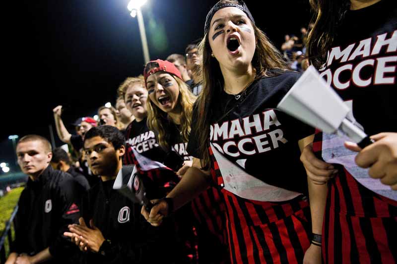 Members of the Maverick Maniacs cheer on UNO men's soccer at the NCAA tournament in Miami