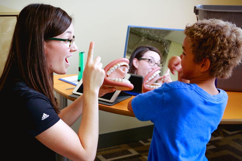 A UNO graduate student works with a young child at UNO's Speech-Language Clinic