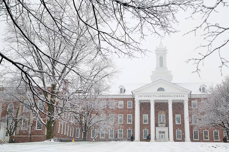 Snow falls on Arts & Sciences Hall 