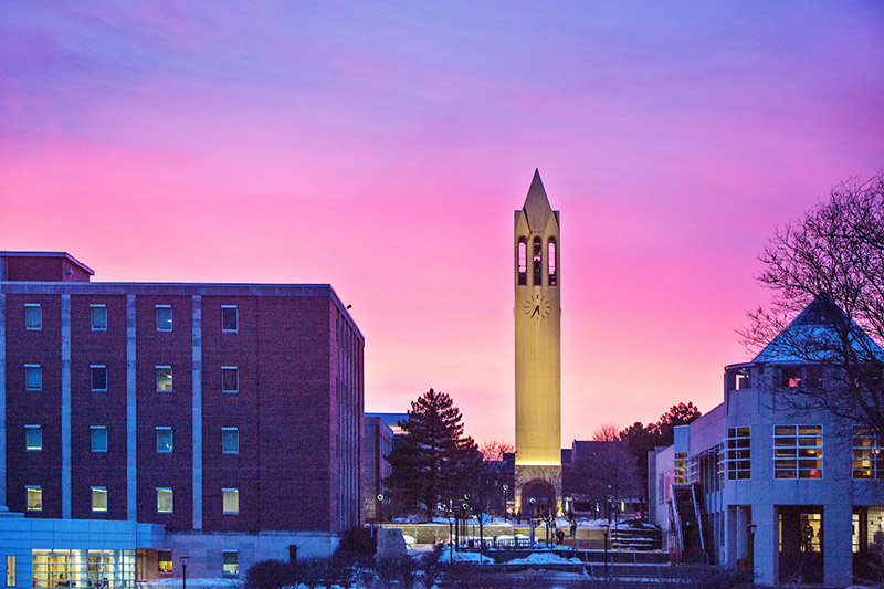 The sun sets behind the UNO Campanile 