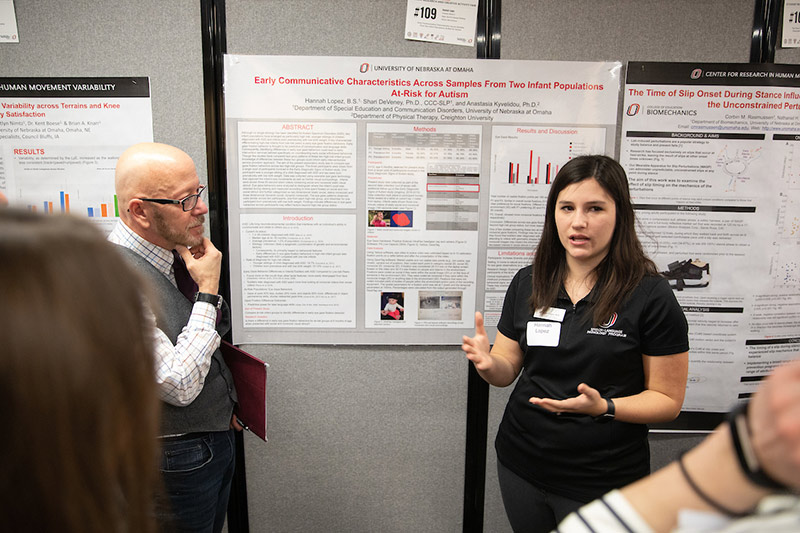A student presents her work during the Student Research and Creative Activity Fair.
