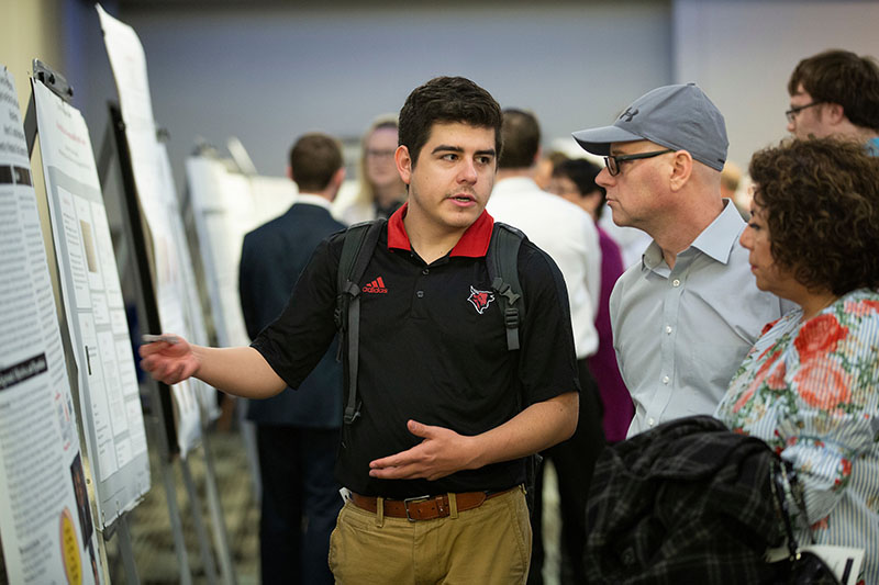 Michael Herndon presents his research during the University Honors Program Symposium in the Milo Bail Student Center at the University of Nebraska at Omaha in Omaha, Nebraska, Thursday, April 18, 2019.