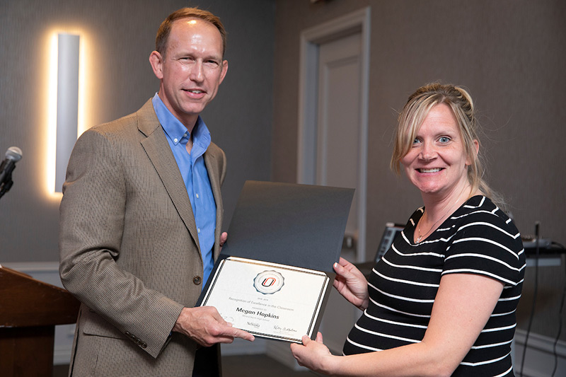 Matt Tracy presents a Recognition of Excellence to Megan Hopkins