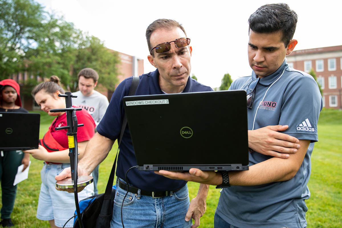 Dr. Dana Richter-Egger, left, and Noyce Scholar Dario Gudino track the movement of a high altitude balloon following its launch. Gudino is a UNO senior and in his second year as a Noyce Scholar.