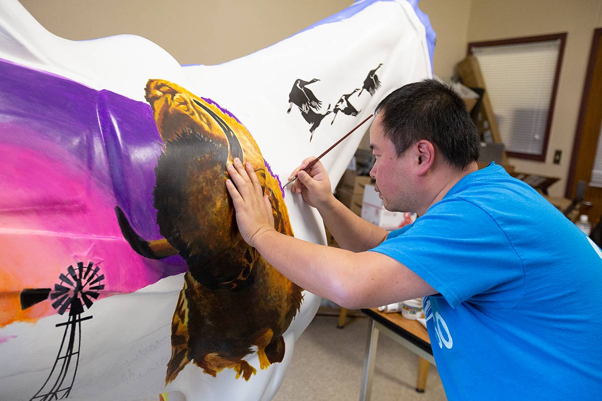 Jave Yoshimoto works on his Horses of Honor piece