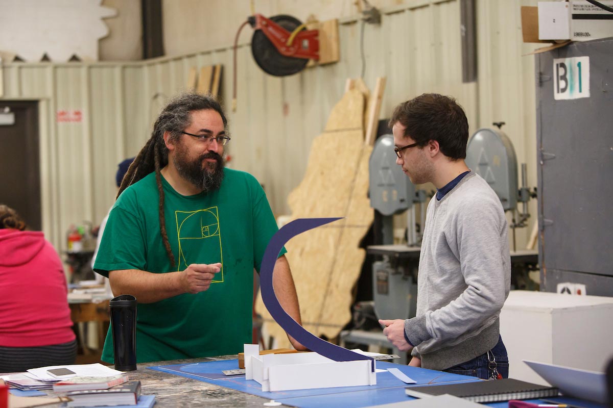 An Instructor and student in sculpture class