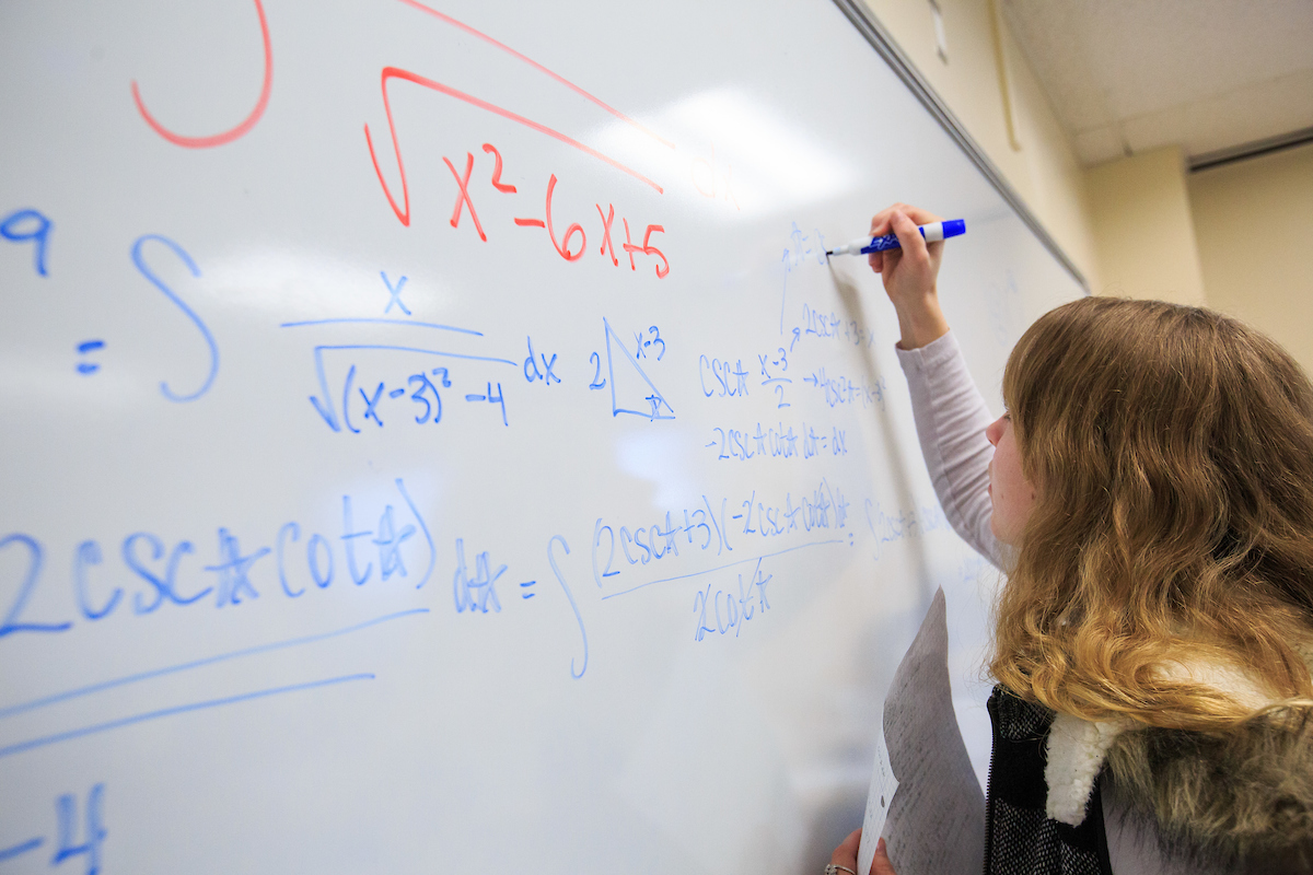 A student completes a Calculus problem during a class at UNO