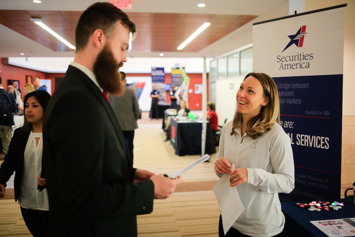 Student talks to a professional at the career fair