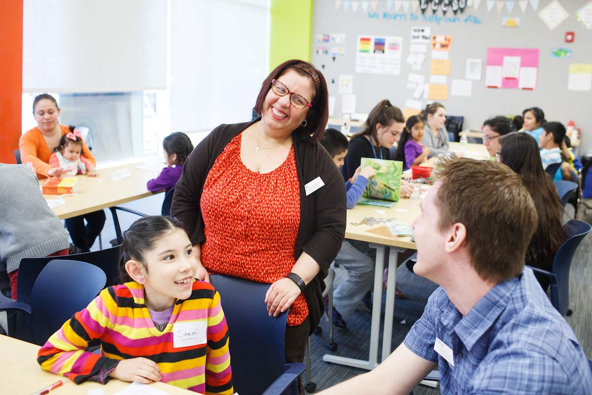 Instructor talking to a student and a child