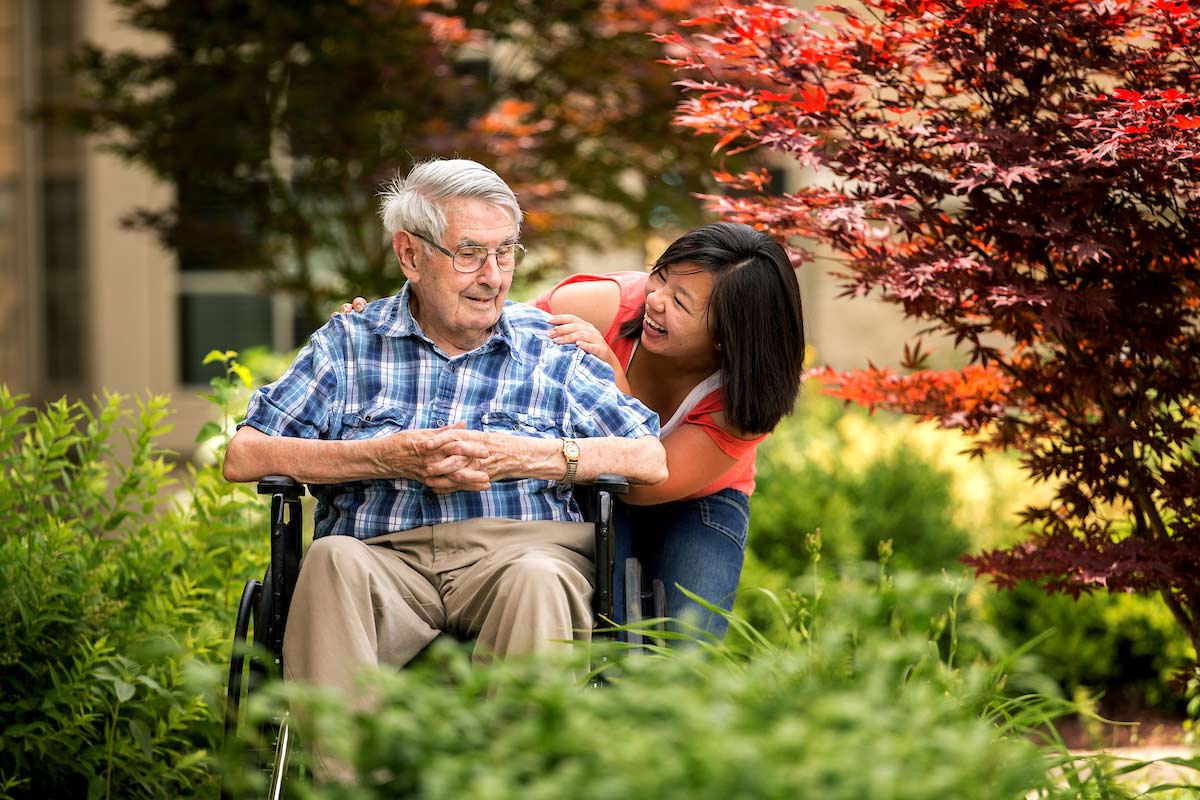 Younger woman talking to an older gentleman