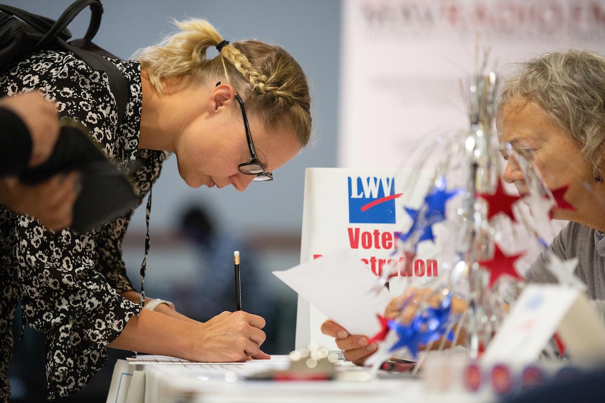 A student registers to vote