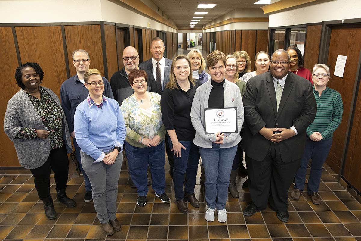 Barb Harvey poses with her office after receiving Employee of the Month