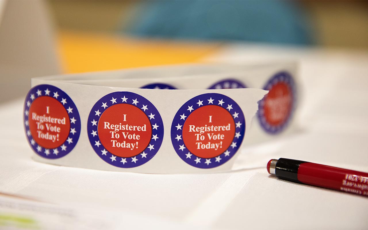 Stickers reading "I registered to vote today" sit on a table in this file photo from a voter registration event held on-campus.