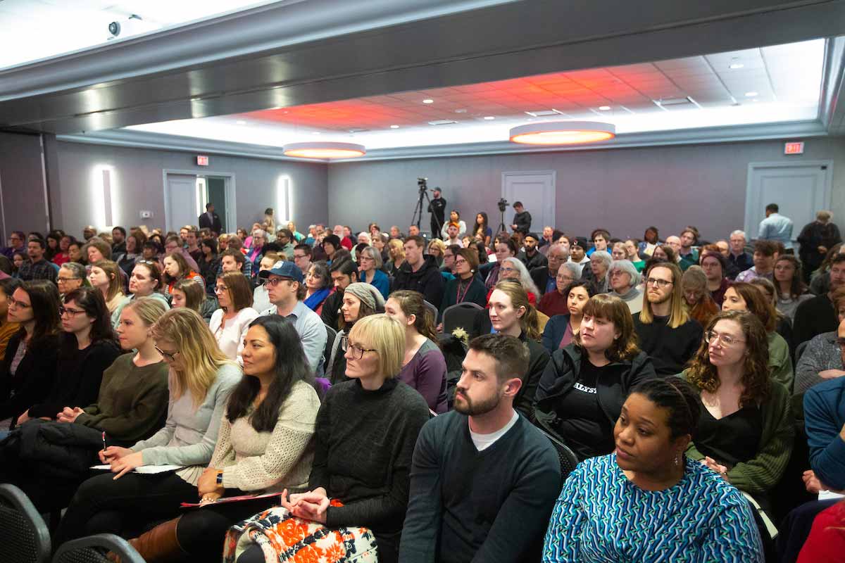 A crowd of people listen to Ibram X. Kendi's speech