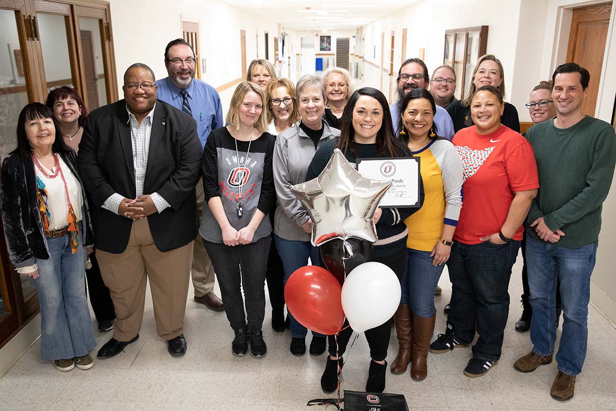 Lindsey Parde poses with coworkers and the Celebration Committee