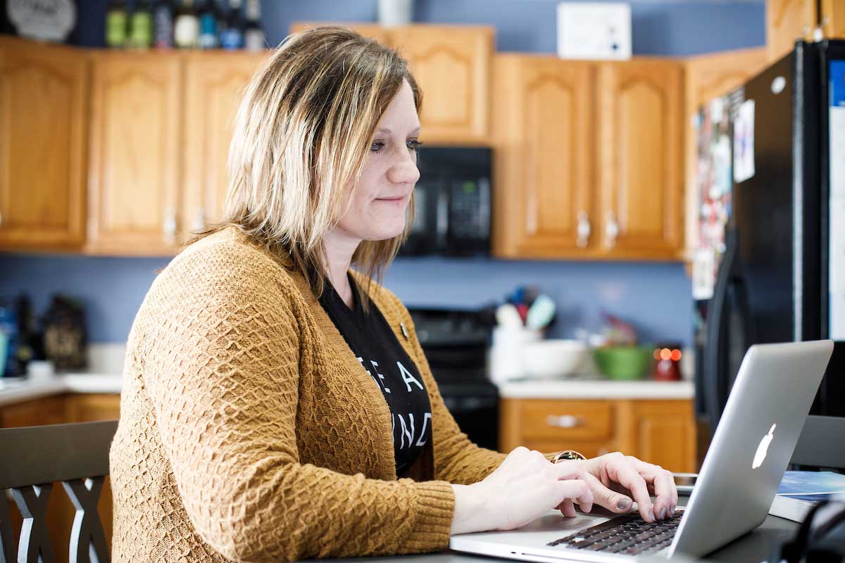 UNO alumna Gina Clyde attends class virtually on her laptop.