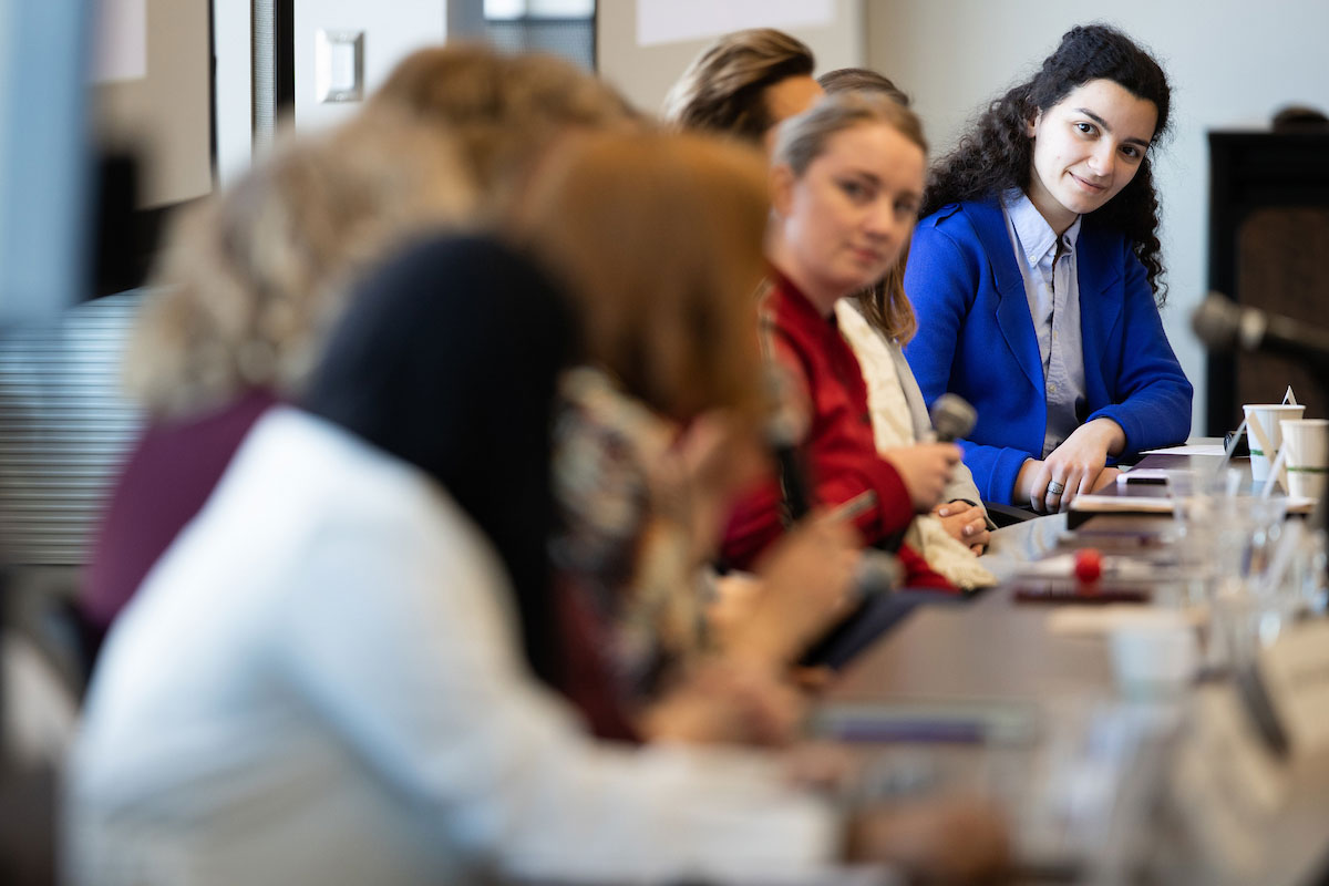 Aya Yousuf listens to a panel of women senators during UNO's Women's Policy Forum