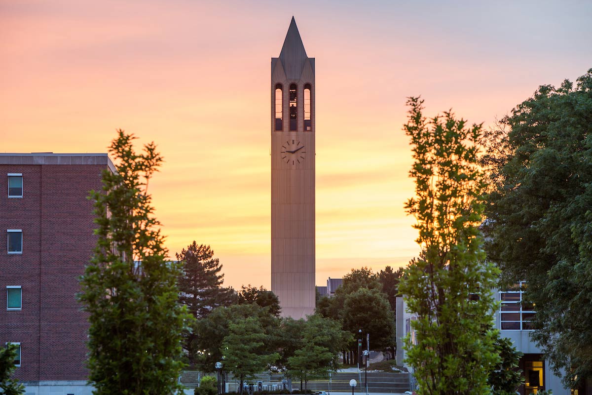 The sun sets behind the Campanile