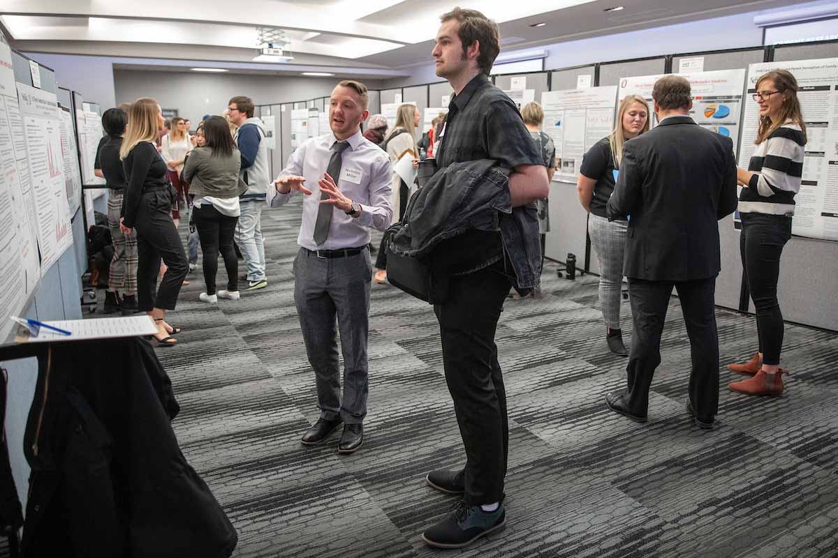 A wide shot of students with poster presentations during the Research and Creative Activity Fair