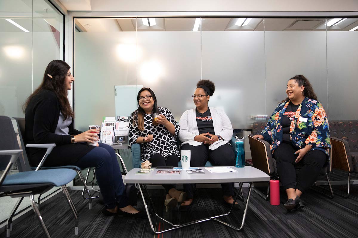 Students and staff talk in the lobby of the Multicultural Affairs Office