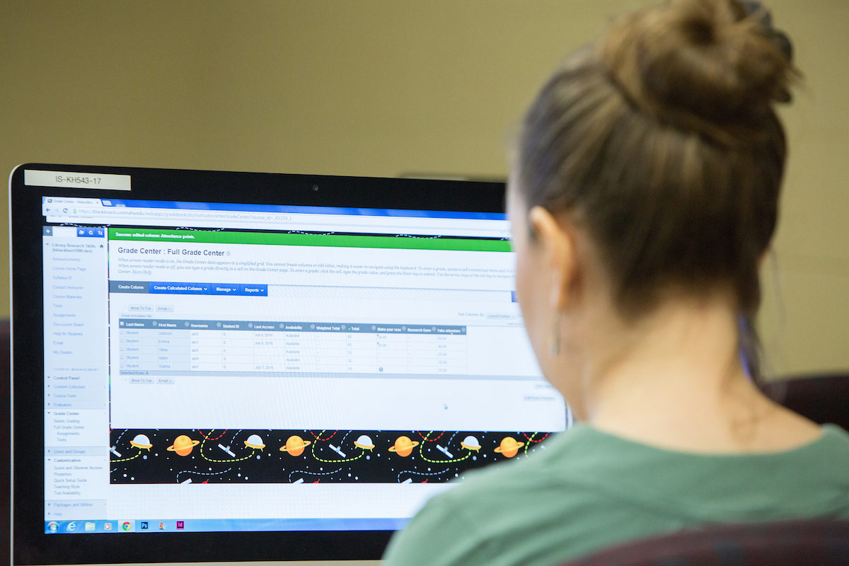 A faculty member training on a computer