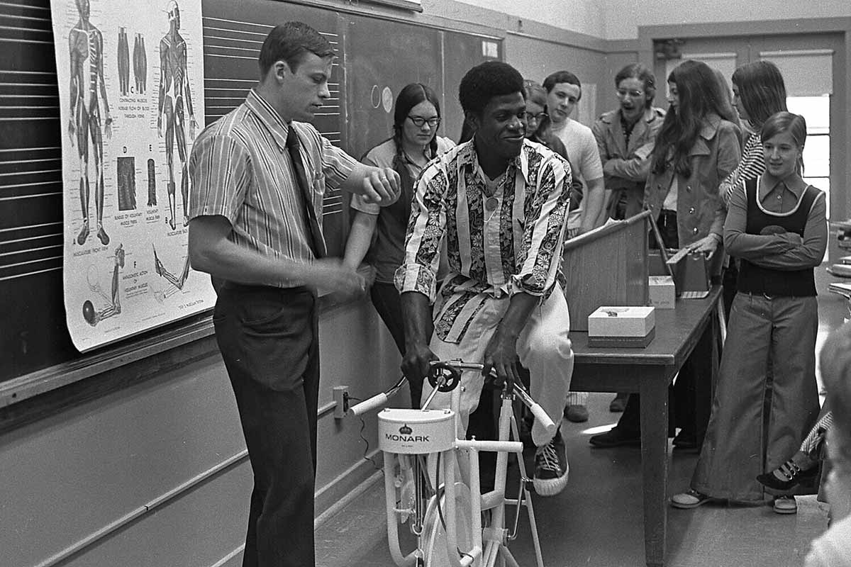 An archival photo of Kris Berg leading an exercise physiology class in 1973.
