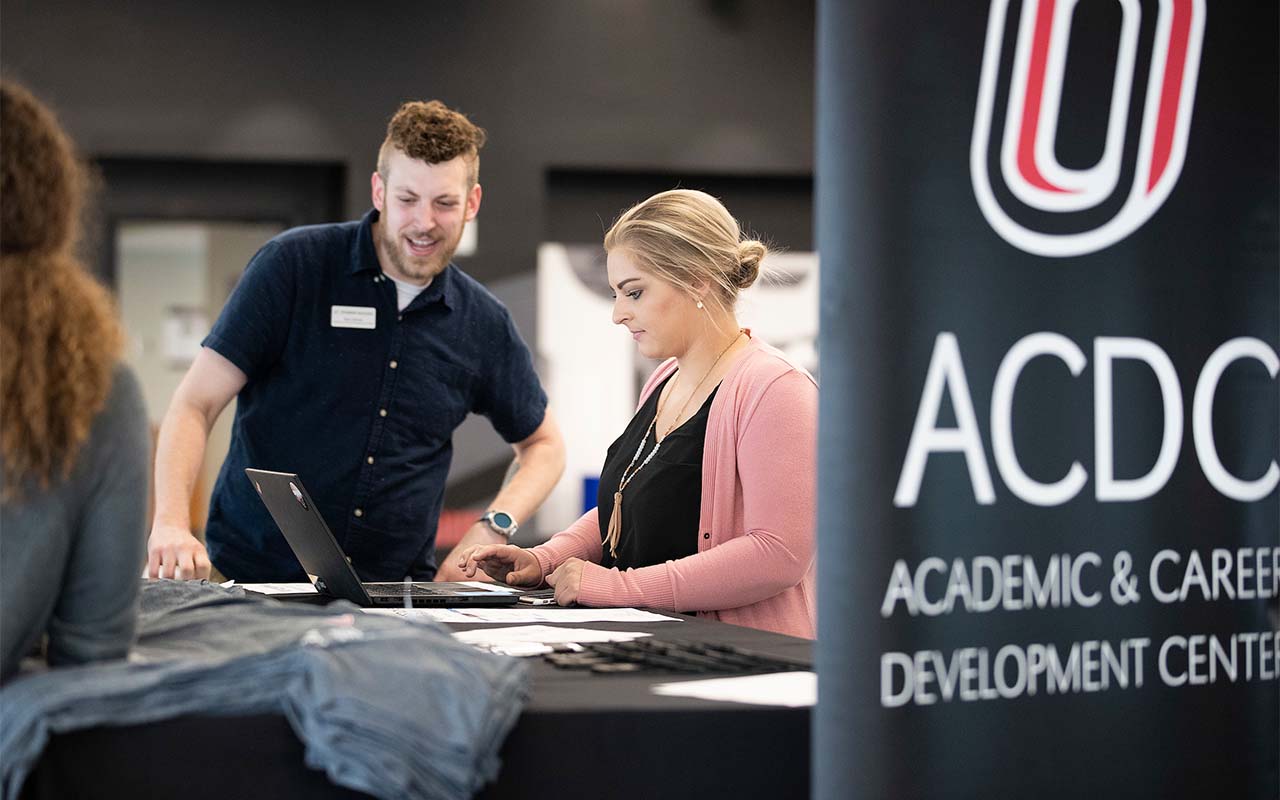 ACDC representatives help students sign up for Handshake while also sampling beverages from The Campus Grind during Jobs and Java in Maverick Landing as part of Durango Days in August 2019.