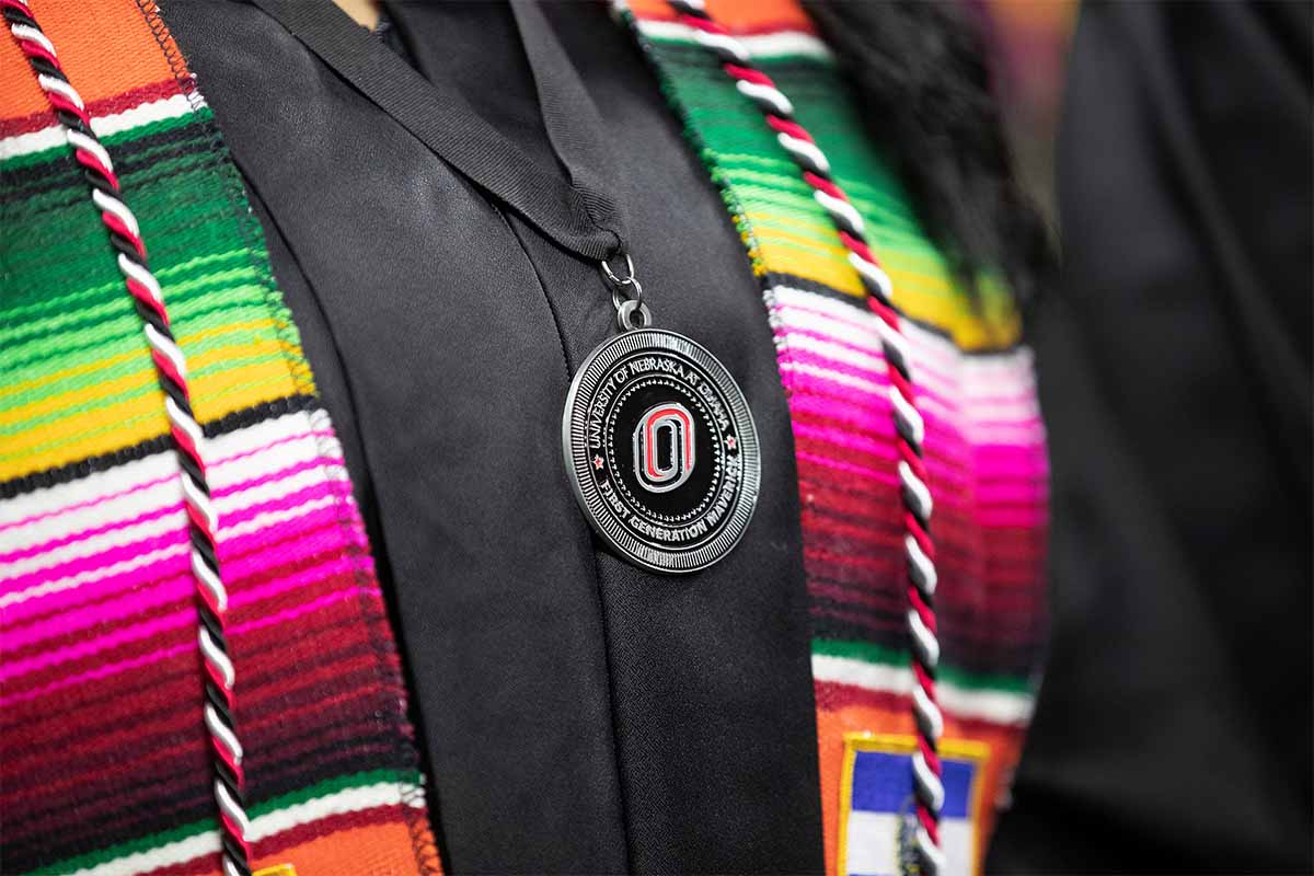 A file photo from Fall 2019 commencement proceedings, showing a student wearing a First Generation Maverick medallion.