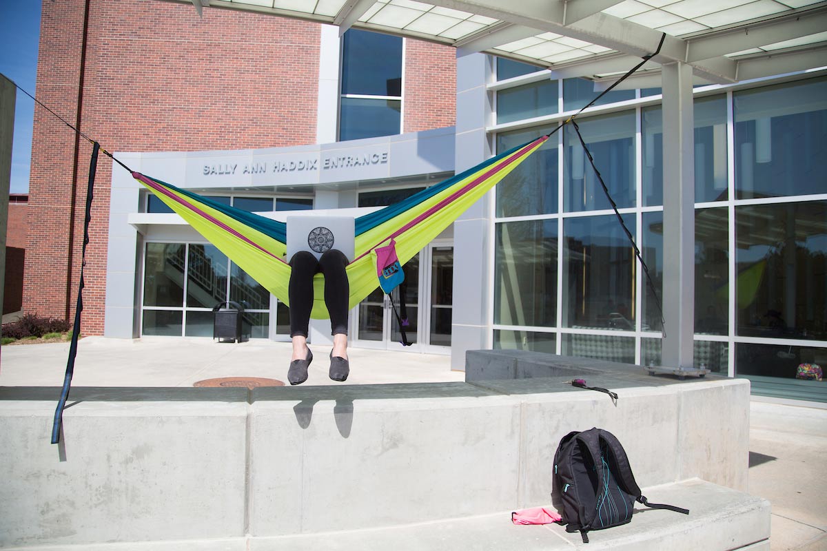 a student lounging in a hammock