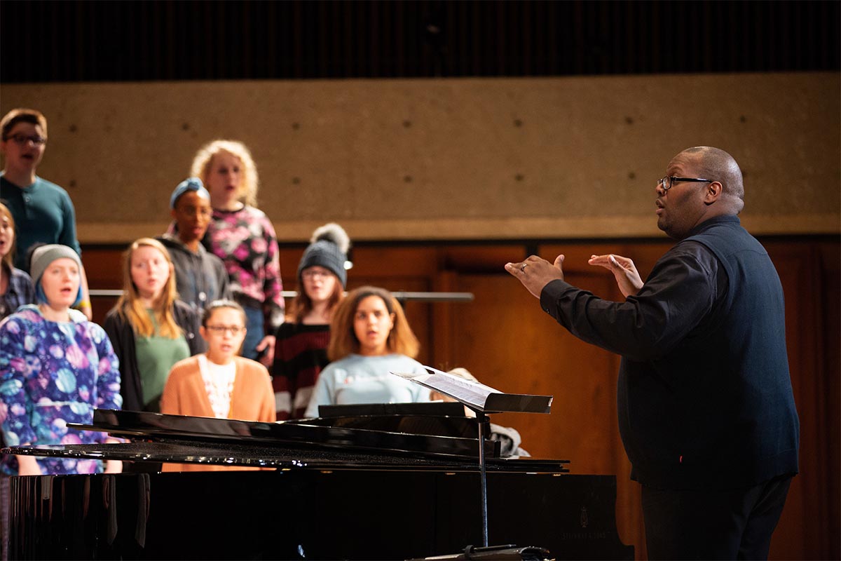 Derrick Fox, DMA, Director of Choral Activities within UNO’s School of Music, conducts a choir rehearsal in UNO’s Strauss Performing Arts Center in March 2019.