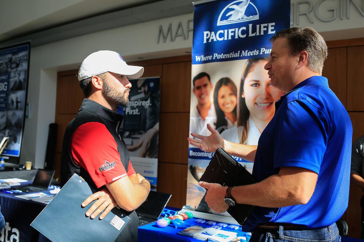 A student talks to a potential employer at a CBA career fair